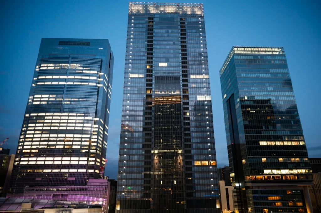 Corporate office towers at dusk representing the closely held company funding an owner executive bonus plan