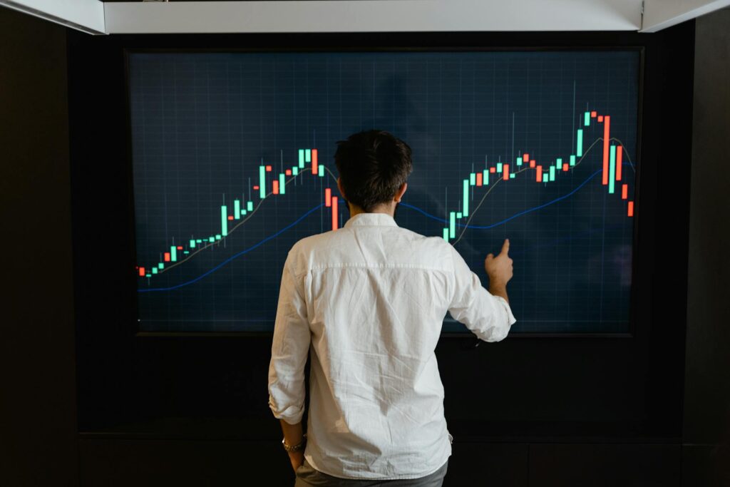 Investor reviewing a rising performance chart, representing a tax-deferred IRA balance compounding into a larger future tax liability