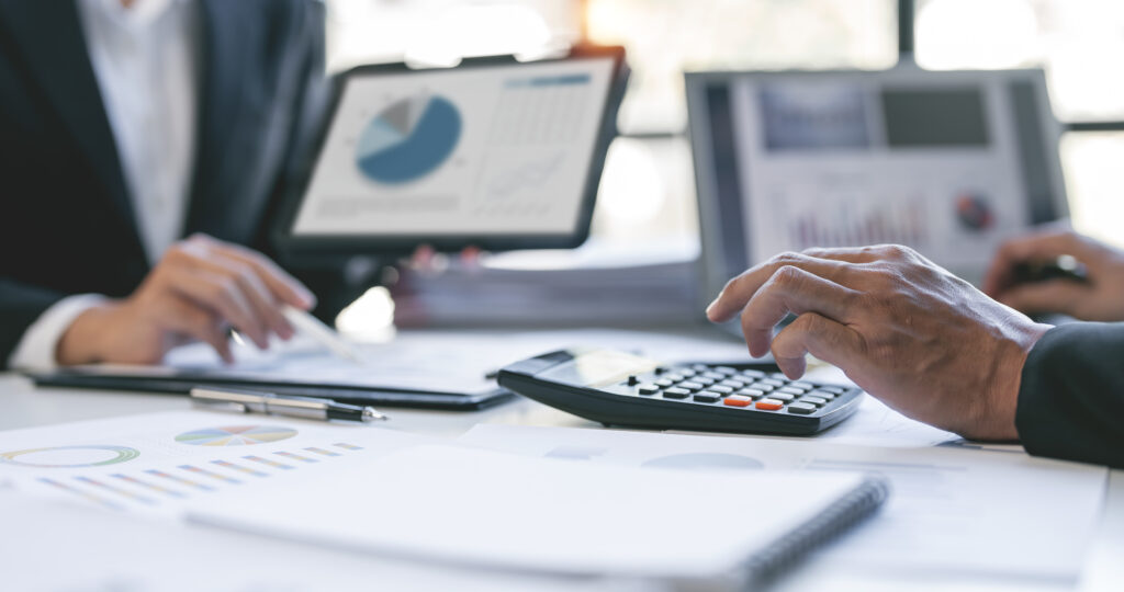 Advisors analyzing financial reports to model the true after-tax proceeds of a business sale