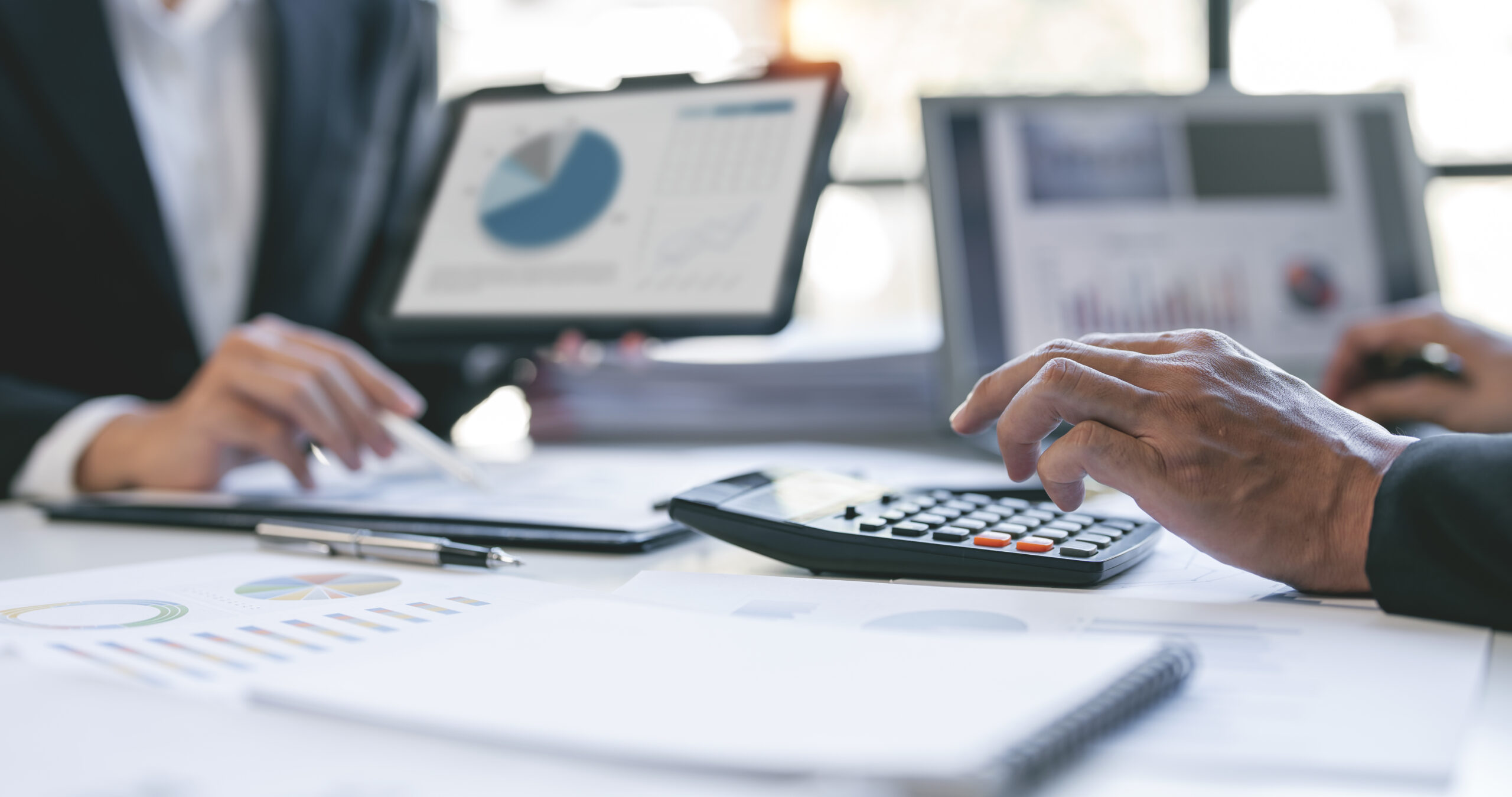 Corporate team analyzing financial reports and qualified-account growth projections